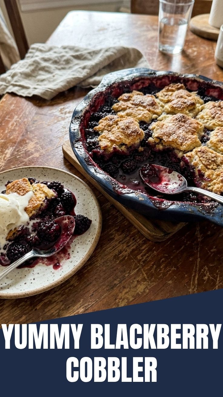 A hot, bubbly blackberry cobbler fresh from the oven, served in a rustic dish.