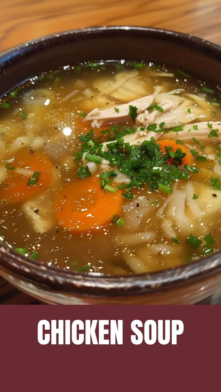 A steaming bowl of chicken soup with vegetables