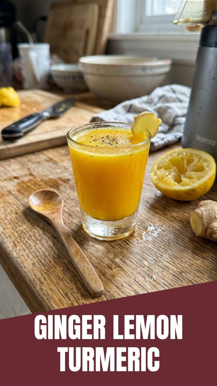 A vibrant ginger lemon turmeric shot in a small glass