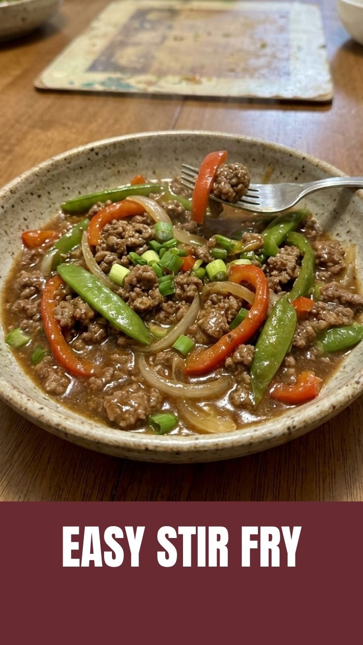 A vibrant ground beef stir fry in a large skillet, ready to serve.