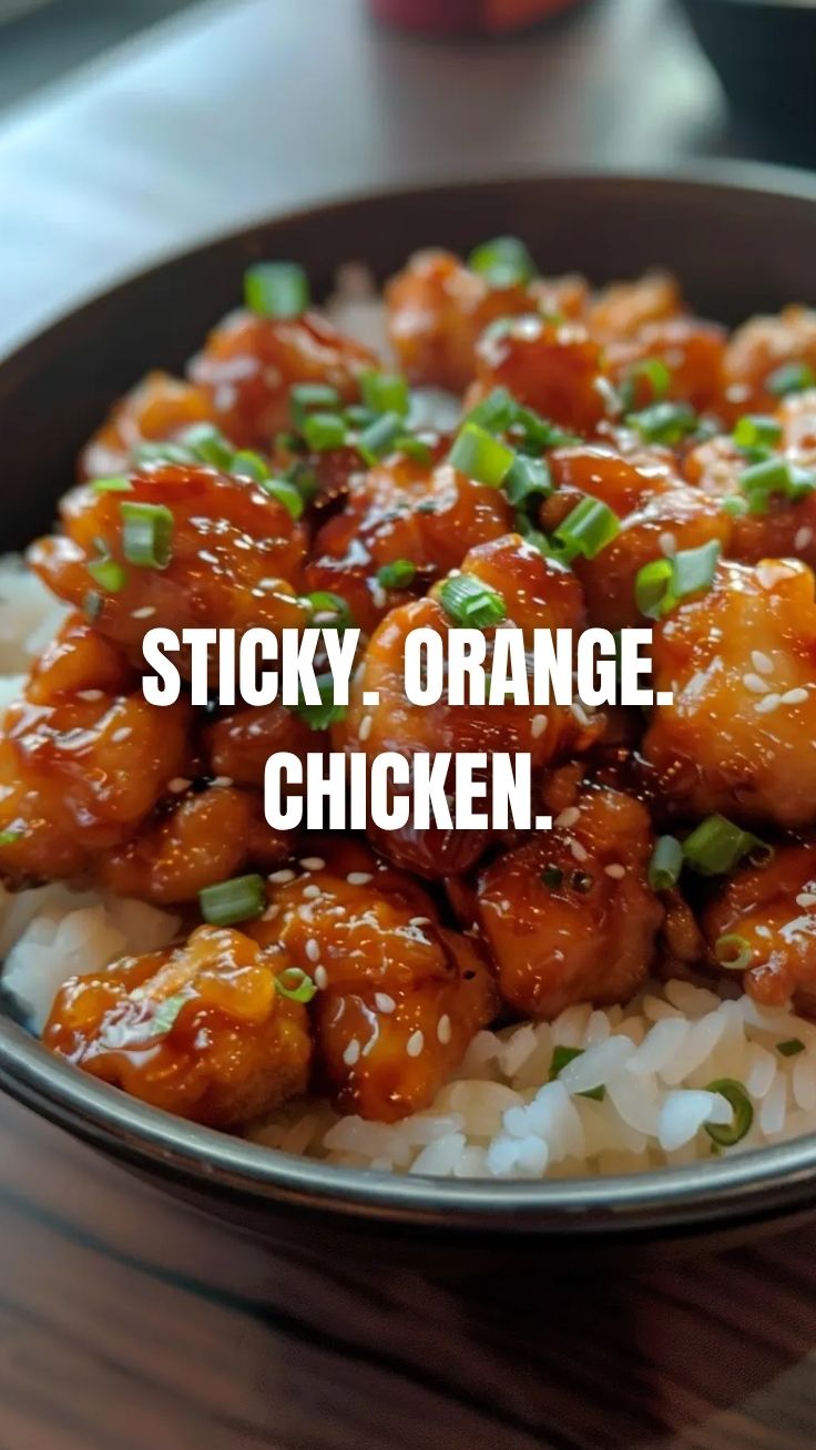 A plate full of crispy Orange Chicken (Panda Express Style) with a glossy sauce.