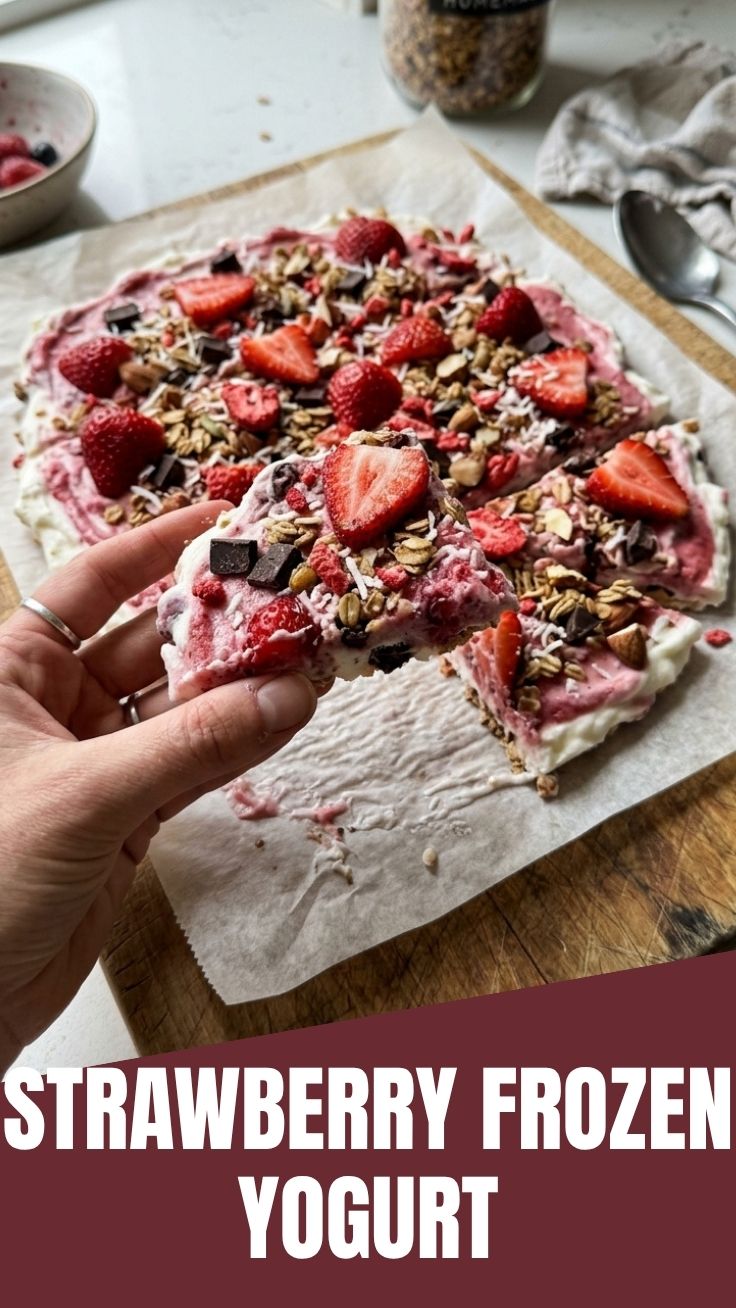 Colorful strawberry frozen yogurt bark with berry pieces