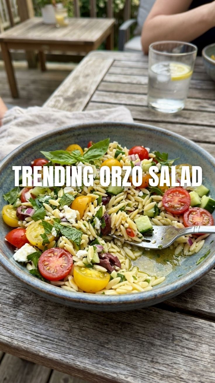 A colorful orzo salad, perfect for summer, served in a large bowl