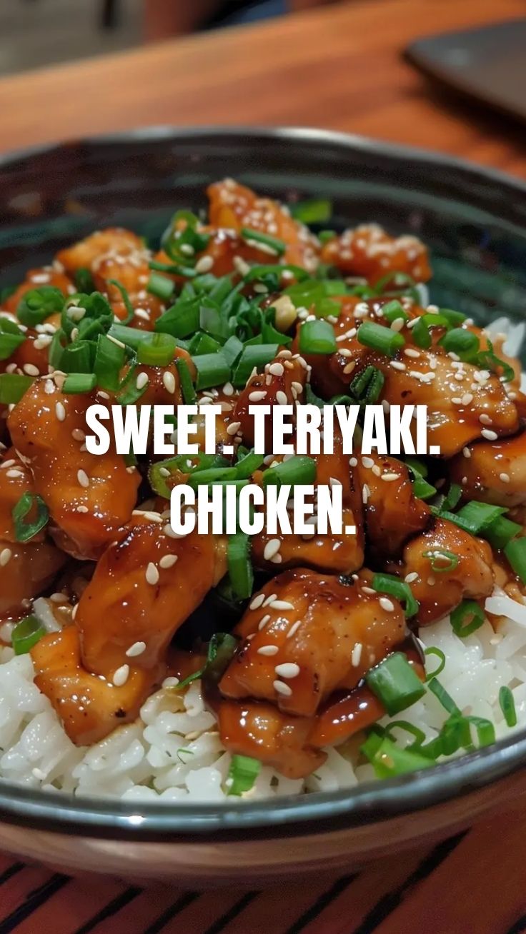 A plate of glistening teriyaki chicken, garnished with sesame seeds.