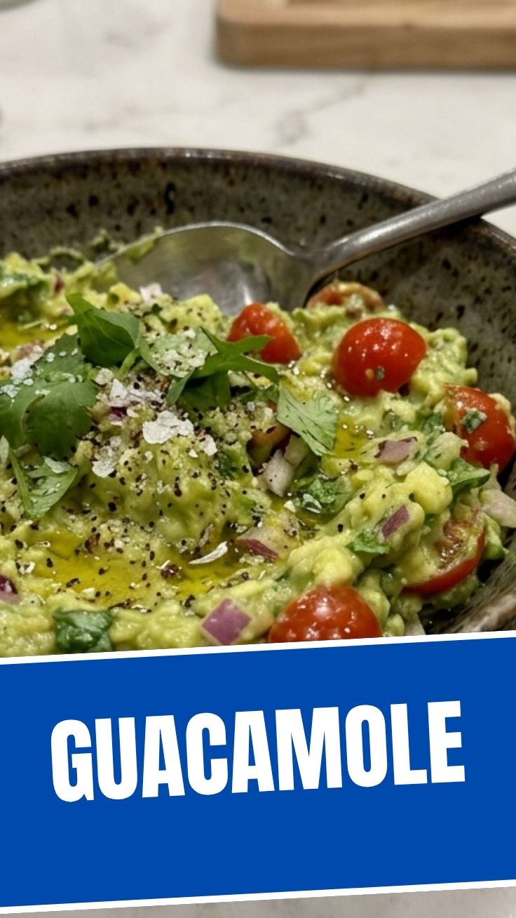 A vibrant bowl of fresh guacamole with chunky avocado pieces and cilantro garnish.