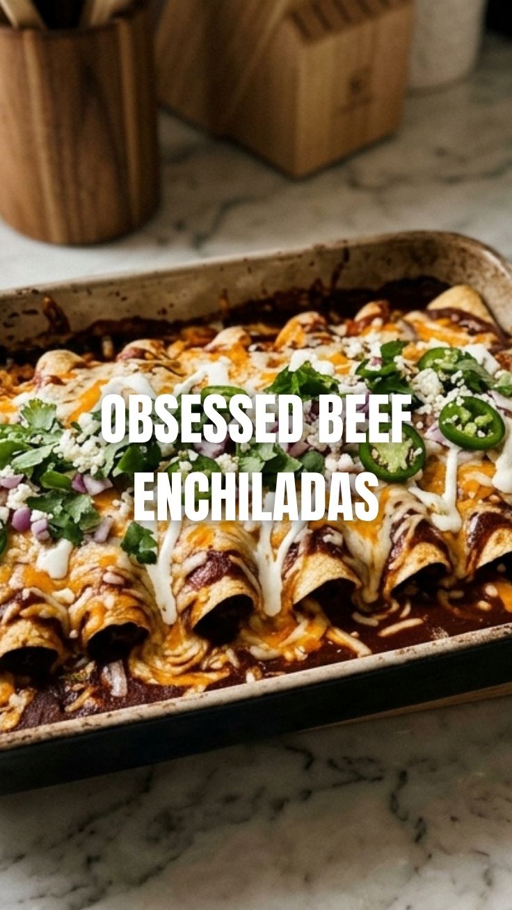 Beef enchiladas bathed in red sauce, topped with melted cheese, and garnished with cilantro