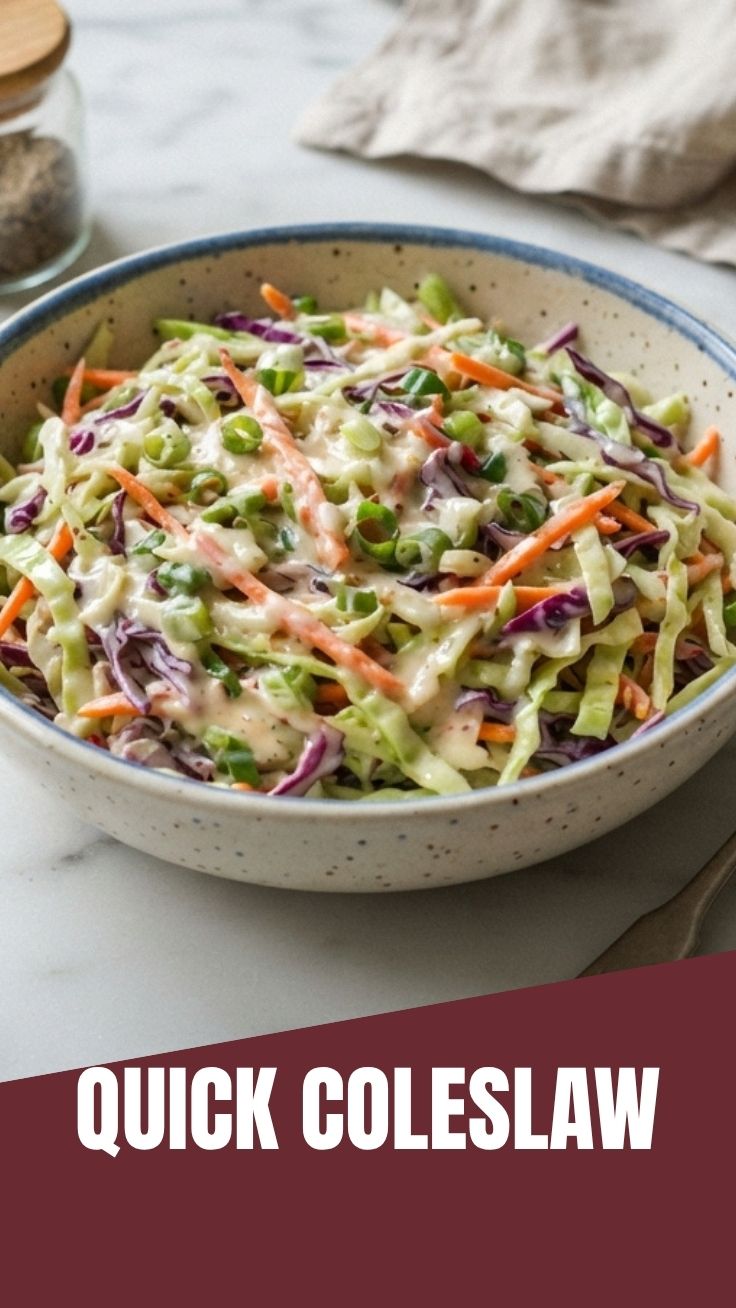 A vibrant bowl of creamy coleslaw made with shredded cabbage and carrots.