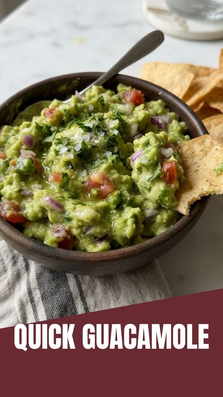 A bowl of fresh guacamole, vibrant green with chunky avocado pieces.